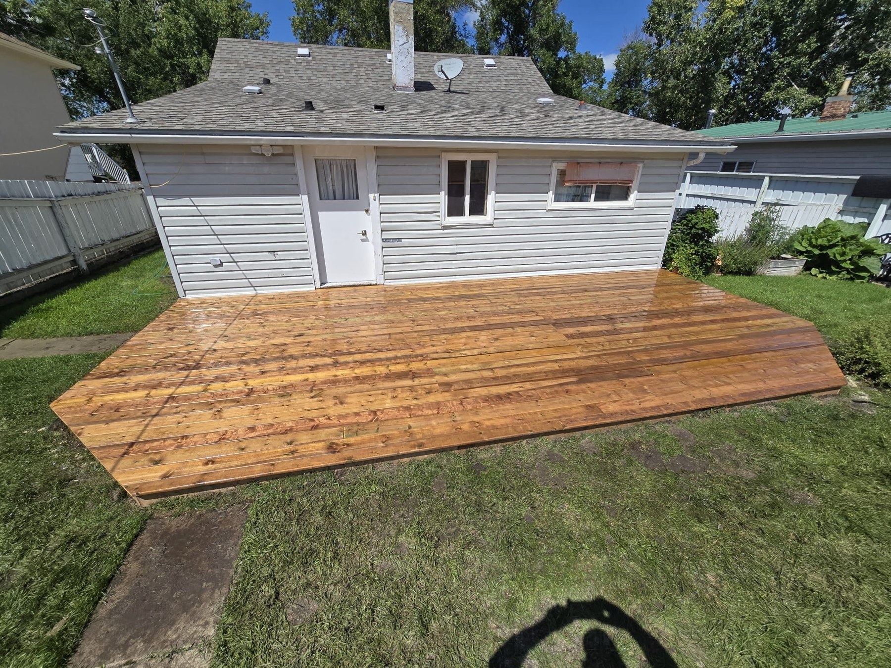 Completed large wood deck at the same white house